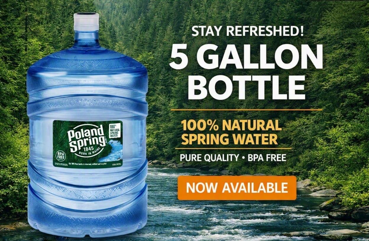 A Poland Spring 5 gallon water bottle in front of a forest stream